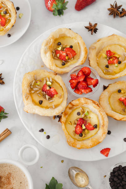 istock Delightful Apple Tartlets with Fresh Strawberries and Nuts 2114411755