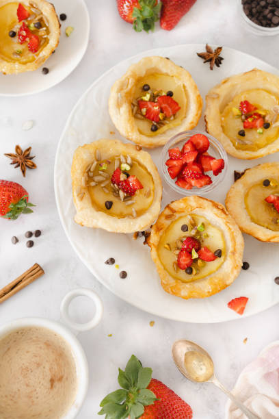 istock Delightful Apple Tartlets with Fresh Strawberries and Nuts 2114411756