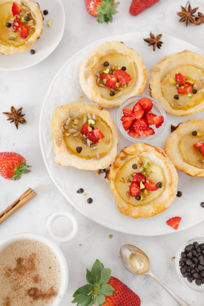 istock Delightful Apple Tartlets with Fresh Strawberries and Nuts 2114411762