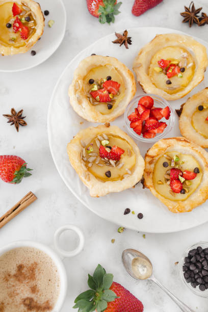 istock Delightful Apple Tartlets with Fresh Strawberries and Nuts 2114411763