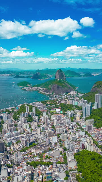 Panoramic view of Sugarloaf Mountain and Botafogo in Rio de Janeiro cityscape, Brazil. Aerial vertical drone hyperlapse.