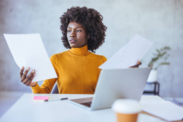 istock Stressed out African American female freelancer working from office using her laptop 2114432693
