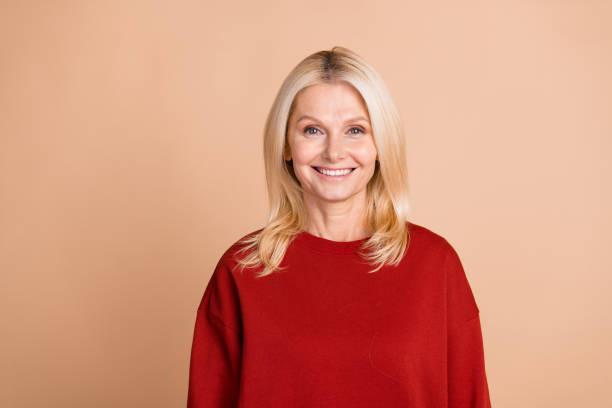 istock Photo of cheerful positive lady dressed red pullover smiling empty space isolated beige color background 2114443874