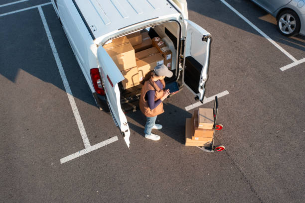 istock Pushing a trolley cart with parcels stacked on it. 2114456125