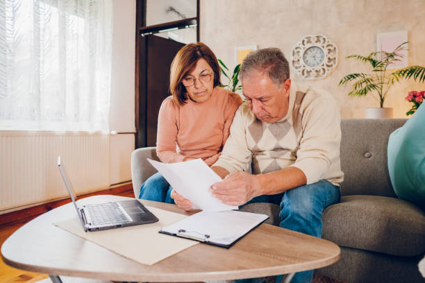istock Couple looking at the bills at home 2114459810