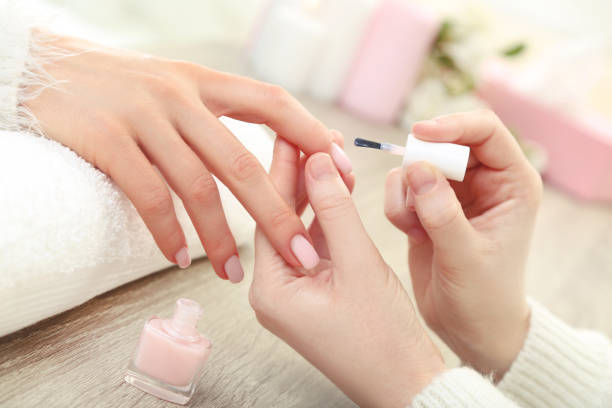 istock Manicurist making manicure for client in salon 2114463965