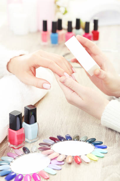 istock Manicurist making manicure for client by nail file 2114471770