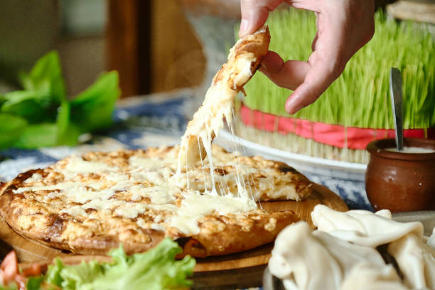 istock Person Takes a Slice of Pizza 2114471783