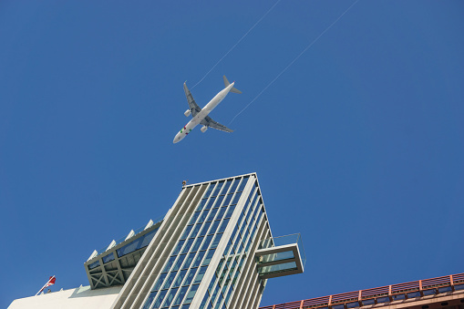 Looking up at an air plane in the sky at Museum and Elevator at the Pilar 7 on the Ponte 25 de Abril or 25the April Bridge, Lisbon, Portugal