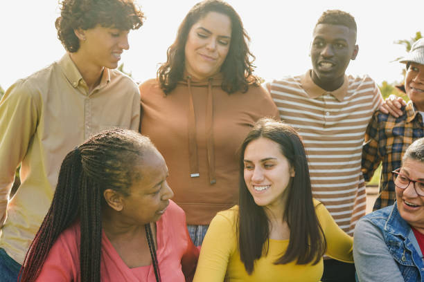 istock Multiracial people with different ages having fun together at city park - Multi generational friends hugging each other outdoor - Community concept 2114494478
