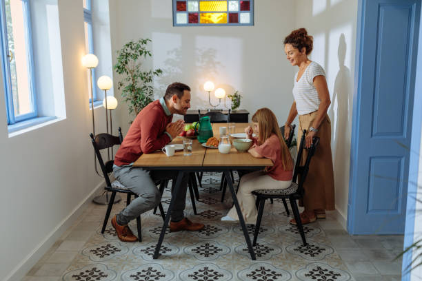 istock Family talking and smiling during breakfast 2114497836