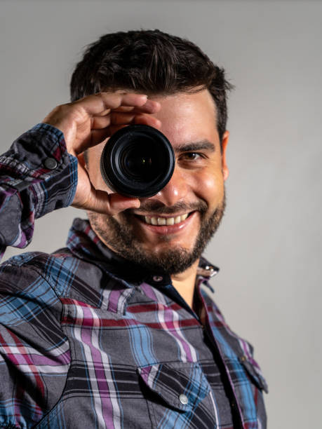 istock Happy man with a new photography lens 2114511426