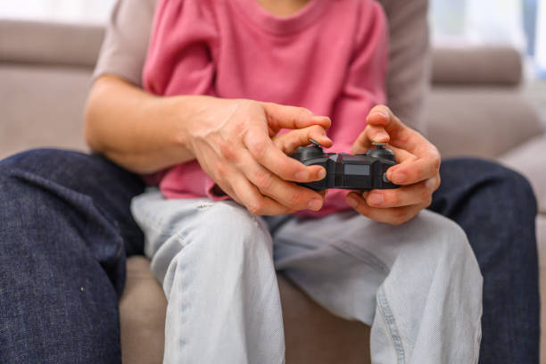istock Father with girl playing video games 2114514530