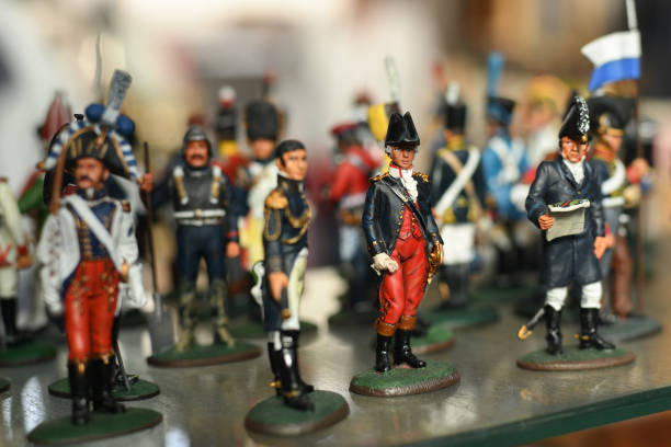 Miniature toy soldier with weapon in hand, white background