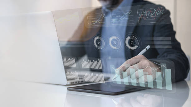 istock Businessman using laptop and tablet analyzing economic data and sales growth on financial charts 2114516087