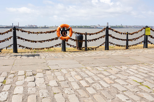 Liverpool, united kingdom May, 16, 2023 Padlocks of love by the river on a bright sunny day.