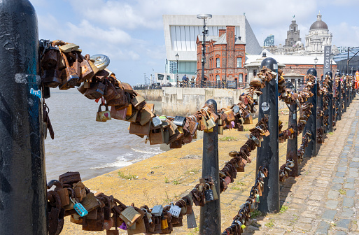 Liverpool, united kingdom May, 16, 2023 Padlocks of love by the river on a bright sunny day.