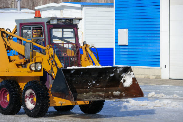 istock A snow plow is driving down a street 2114592545