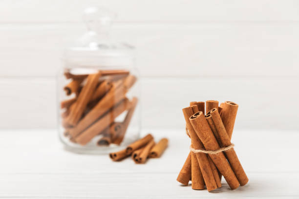 Cinnamon sticks on a textured wooden background. Cinnamon roll. Spicy spice for baking, desserts and drinks. Fragrant ground cinnamon. cinnamon powder Close-up. Place for text. copy space