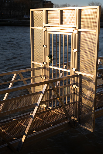 A boat ramp with attached railings by the water's edge