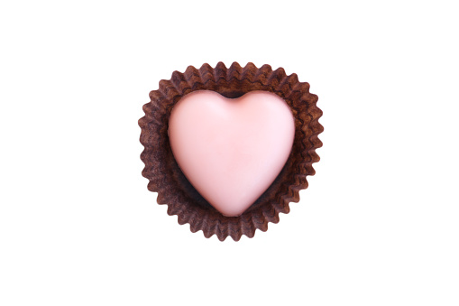 Pink heart shaped chocolate in wrapper isolated on white background, Chocolate candy