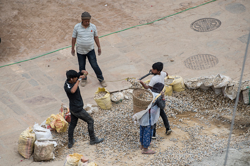 Kathmandu, Nepal- April 20,2022 : Local people of all ages and gender are working to rebuild the ruined old city in a major earthquake in Kathmandu.