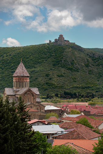 The Svetitskhoveli Cathedral, an Orthodox Christian cathedral located in the center of the historic town of Mtskheta, Georgia, with the Jvari Church high on a hilltop in the distance.