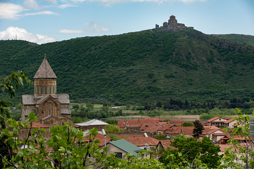The Svetitskhoveli Cathedral, an Orthodox Christian cathedral located in the center of the historic town of Mtskheta, Georgia, with the Jvari Church high on a hilltop in the distance.