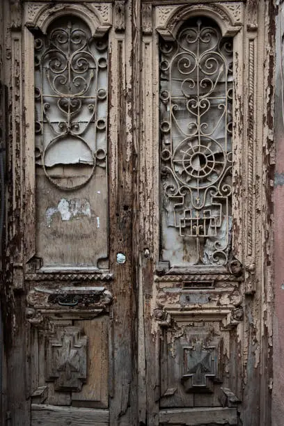 Photo of Old, broken, wooden doors at the entrance to a condemned building in historic Old Town, Tbilisi, Georgia.