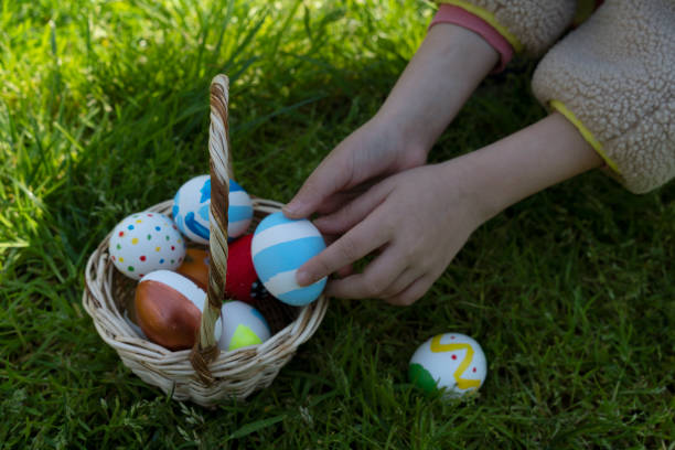 istock Colorful Easter eggs in little girls hand 2114648391
