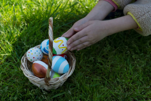 istock Colorful Easter eggs in little girls hand 2114661519
