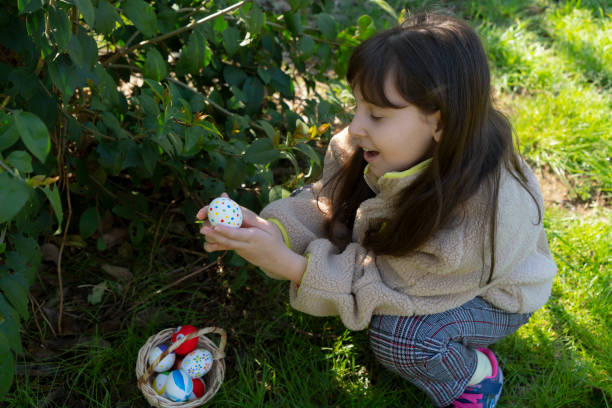 istock Colorful Easter eggs in little girls hand 2114666415