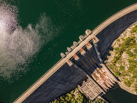 Aerial view of a closed dam wall in a mountain Hydroelectric power plant.