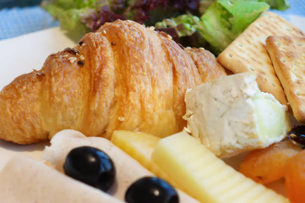 Stock photo showing close-up view of continental breakfast ingredients on a white plate selected from a self service hotel breakfast buffet.
