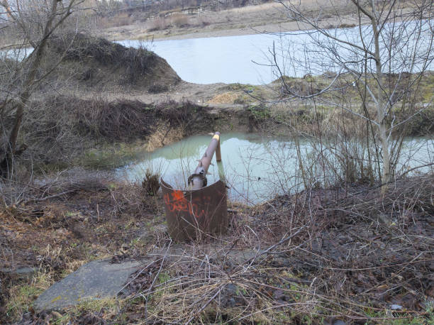istock An industrial pipe discharges hazardous waste into the river. 2114676802