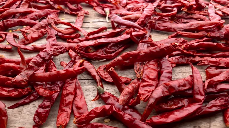 Dried chili peppers on an old weathered wood background.