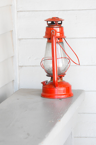 Old rusty kerosene lamp on a white background. Lighting equipment. Roofing lamp. Retro style. White background. Background image. Place for text.