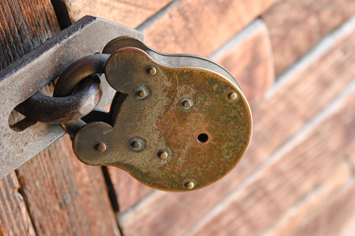 Landscape photo of a close up view of a locked shed where key is required to unlock