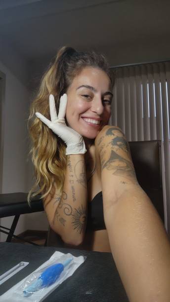 istock Tattoo artist taking selfie with surgical glove 2114701399