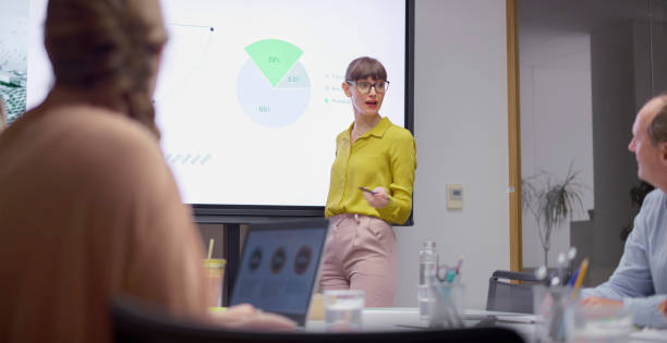 istock Businesswoman giving presentation with graph 2114723418