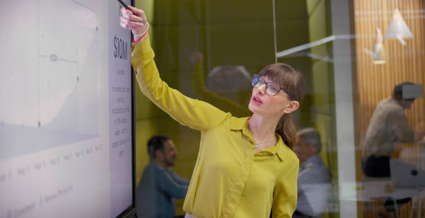 istock Businesswoman giving presentation with graph 2114723429