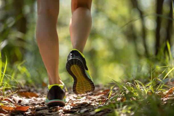 istock Woman runner running on forest trail 2114731294
