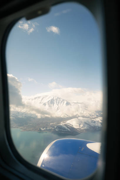 Snowy mountain and lake view from airplane window