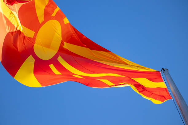 istock North macedonia flag waving in sunny blue sky. 2114761658