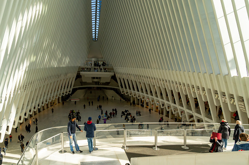Wall Street, Manhattan, New York, USA - March, 2024. Oculus building in Wall Street from inside the transport hub.Also known as The World Trade Center Transportation Hub. It is the Port Authority of New York and New Jersey's formal name for the new PATH station and the associated transit and retail complex that opened on March 3, 2016. It was designed by Spanish architect Santiago Calatrava and composed of a train station with a large and open mezzanine under the National September 11 Memorial plaza. This mezzanine is connected to an above ground structure called the Oculus—located between 2 World Trade Center and 3 World Trade Center—as well as to public concourses under the various towers in the World Trade Center complex.