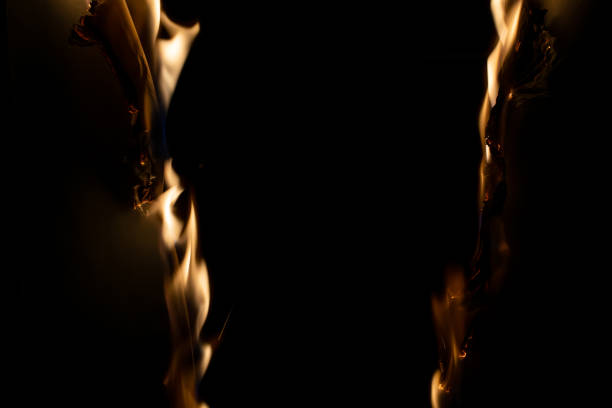 burning paper, glowing edge of paper on a black background