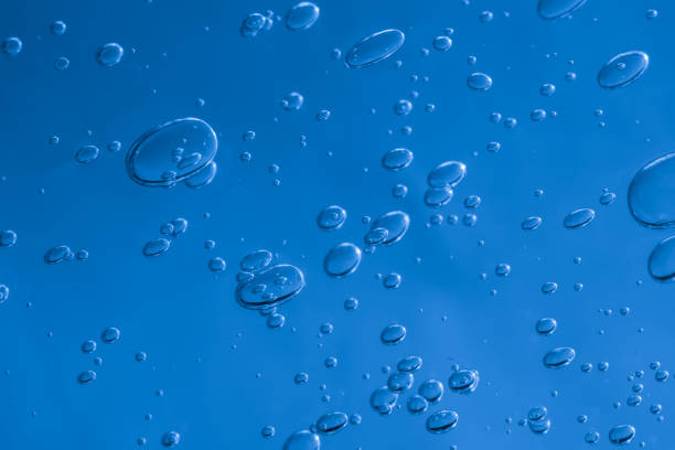 istock air bubbles in water. dark space background 2114766425