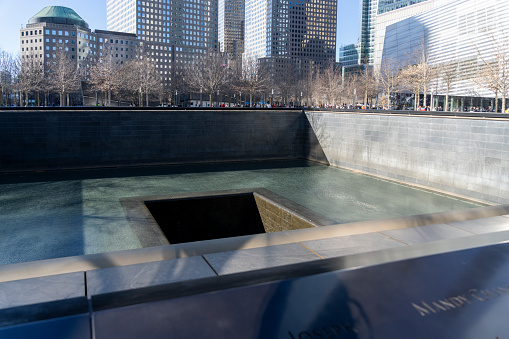 Ground Zero Memorial in south Manhattan in memoriam of September 11 World Trade Center Terrorist Attacks. Some engraved names of the victims are showed. Patriot Day - New York NY USA