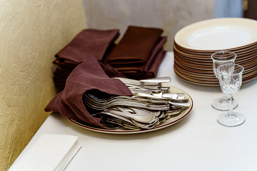 Lots of clean cutlery for restaurant table setting