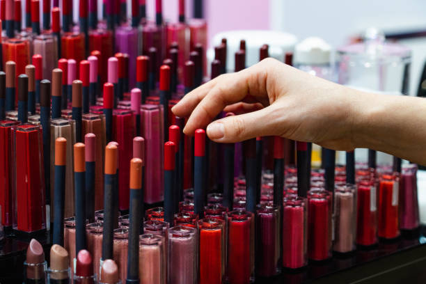 istock Woman chooses a lipstick in a cosmetics store 2114776000